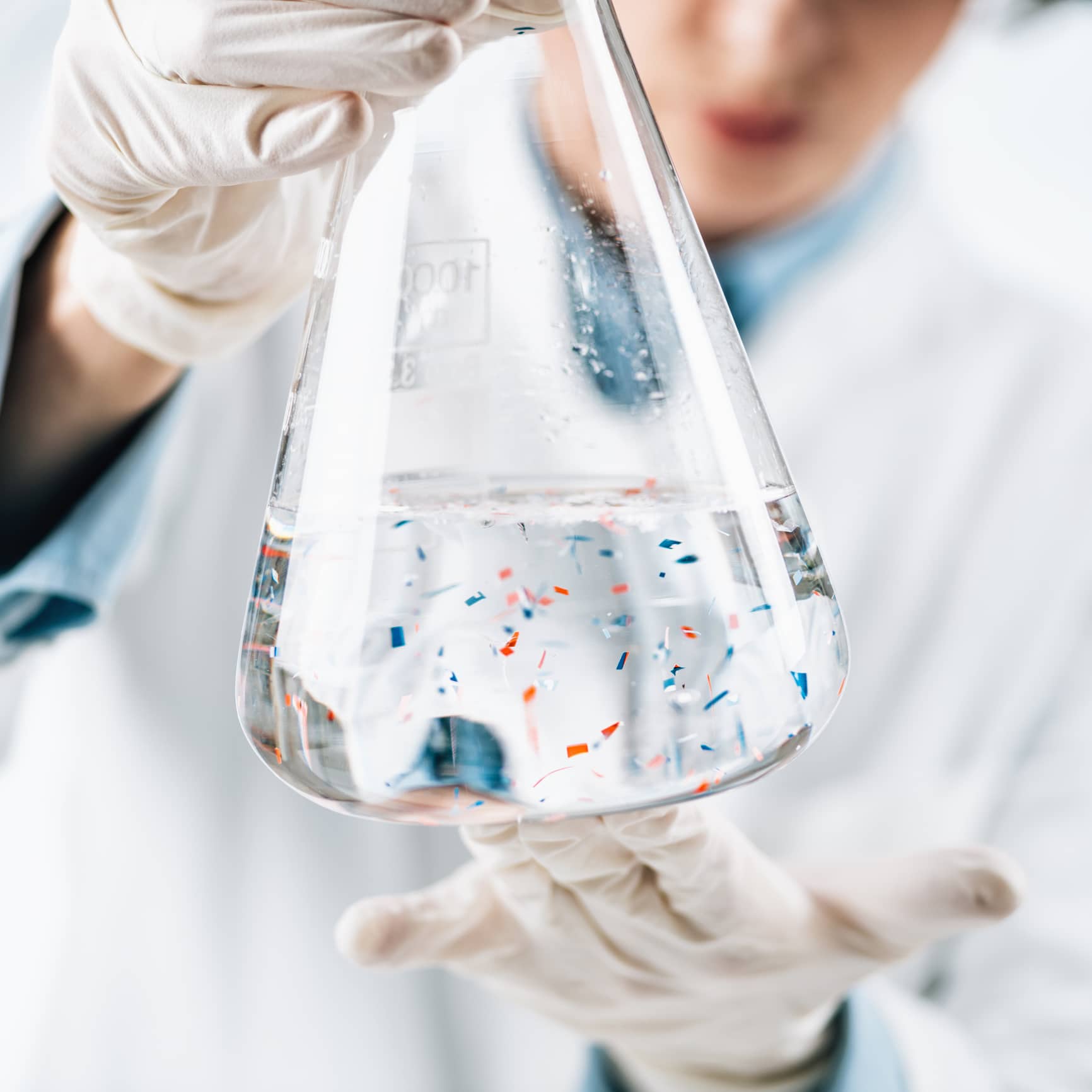 Microplastics Laboratory Analysis. Scientist Observing Microplastics Or Tiny Plastic Particles